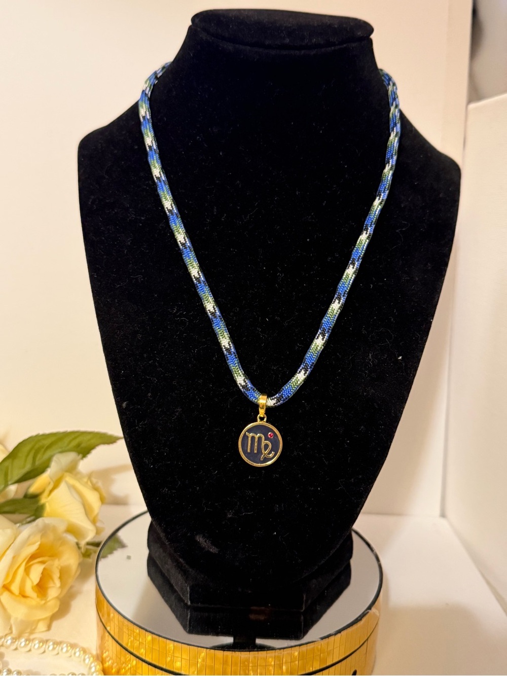 Roxanne Assoulin Braided Blue and Green Cord Necklace with Gold Virgo Charm